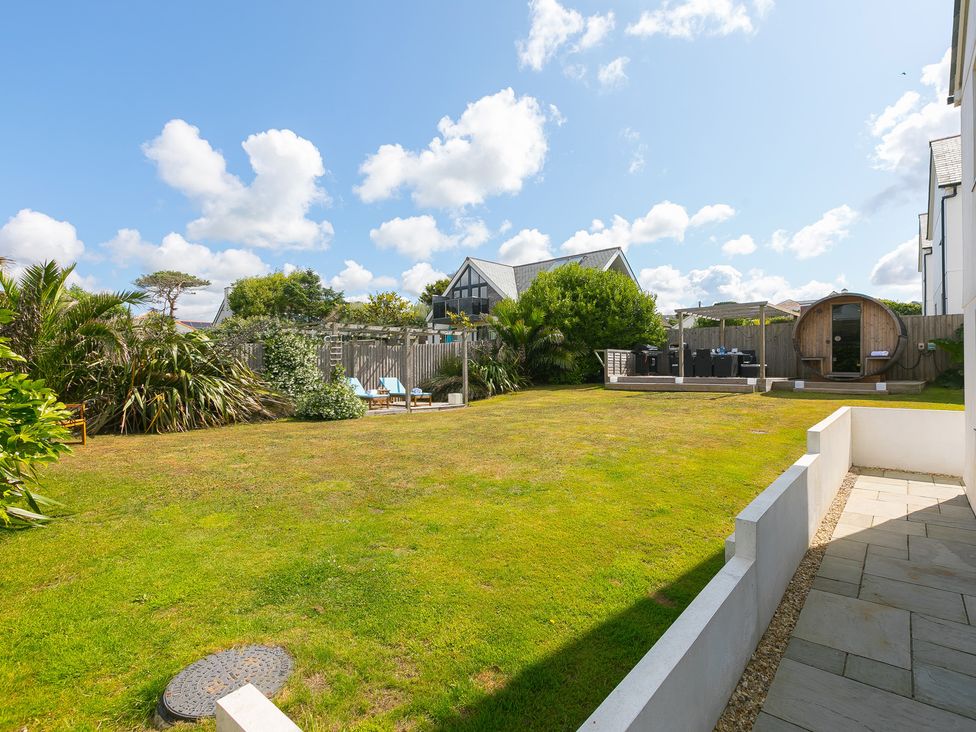A garden with grass and furniture at Sandbanks in Praa Sands