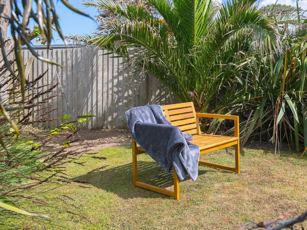 A bench with a blanket in a garden at Sandbanks, Praa Sands