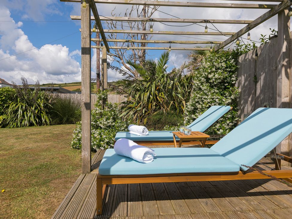 A garden with loungers and towels at Sandbanks in Praa Sands