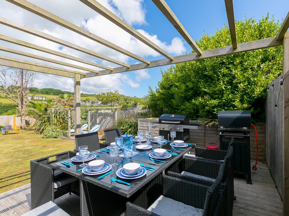 An outdoor dining area with a table and chairs at Sandbanks in Praa Sands