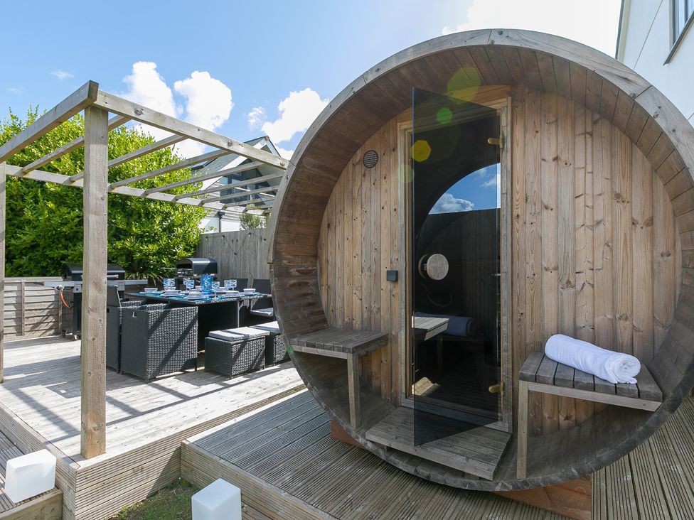 An outdoor area with a sauna and dining setup at Sandbanks in Praa Sands