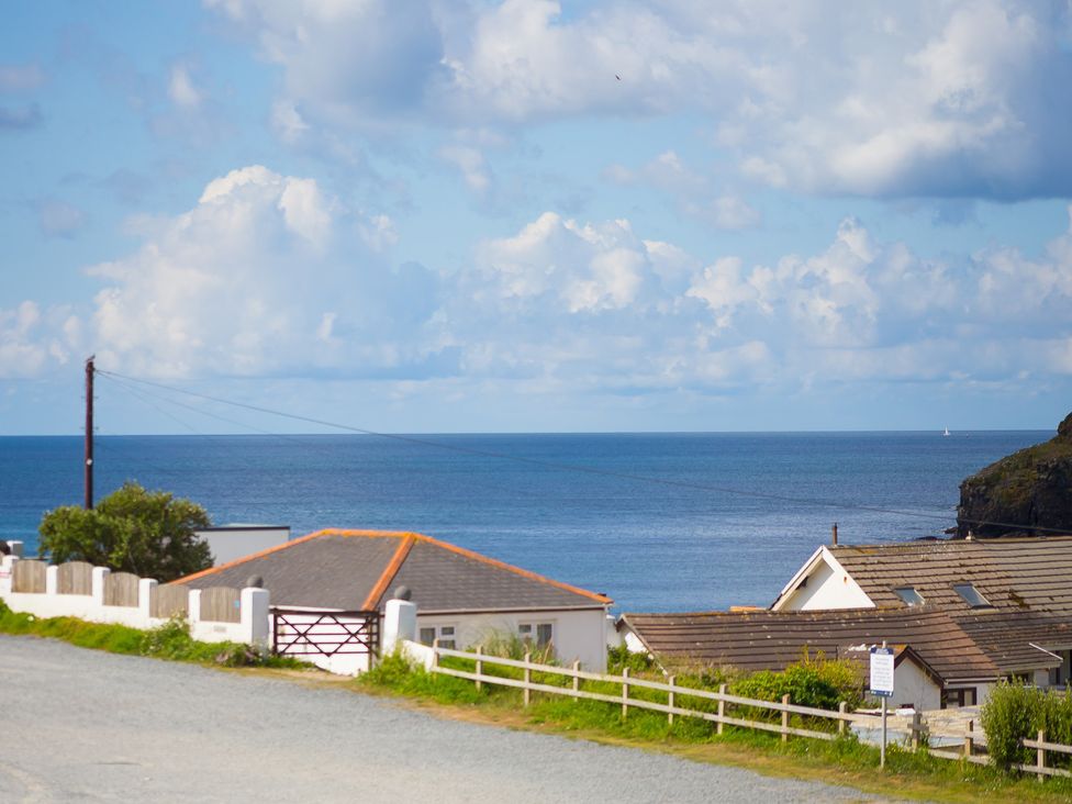An outdoor view of the ocean and houses at Sandbanks in Praa Sands
