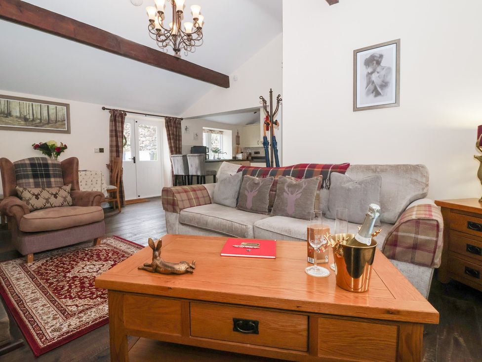 A living room with a sofa and armchair at Beckside Cottage in Cowling near Skipton