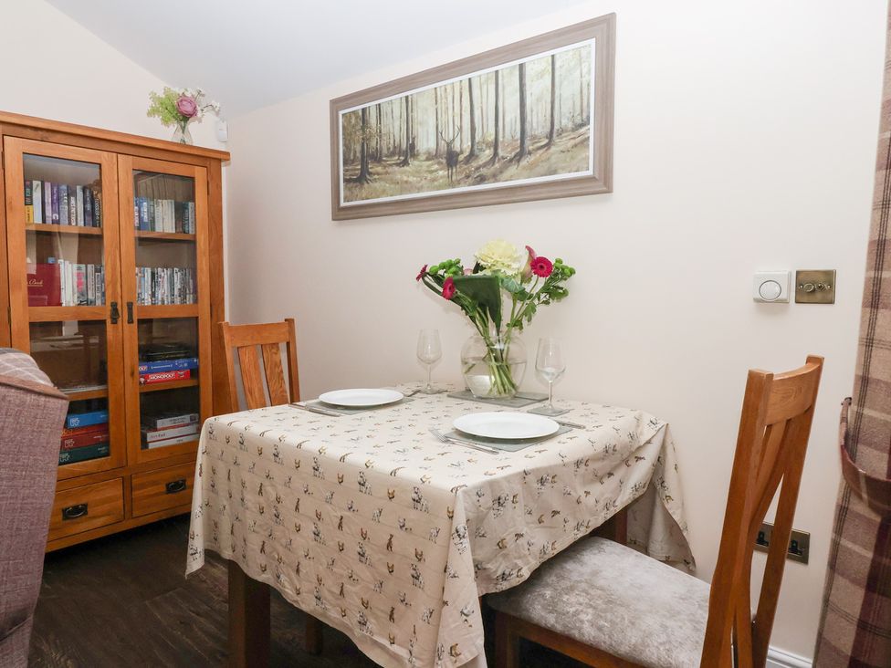 A dining area with a table and chairs at Beckside Cottage in Cowling near Skipton