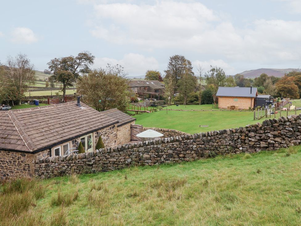 An outdoor view of buildings and grass at Beckside Cottage in Cowling near Skipton