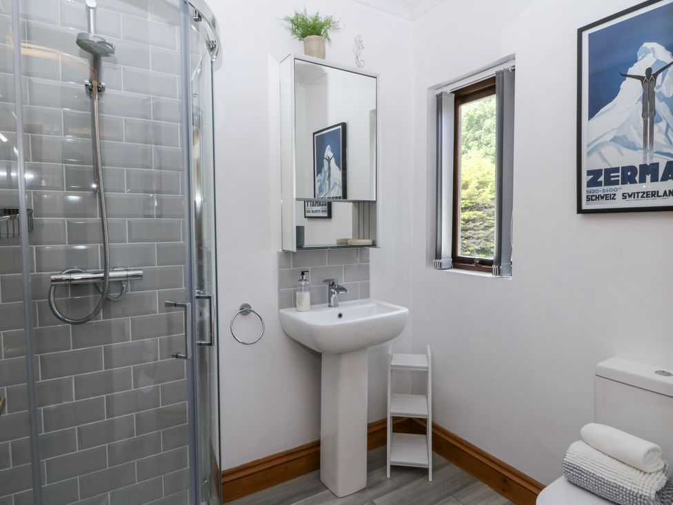 A bathroom with a shower, sink, and toilet at Kala Spittal near Haverfordwest