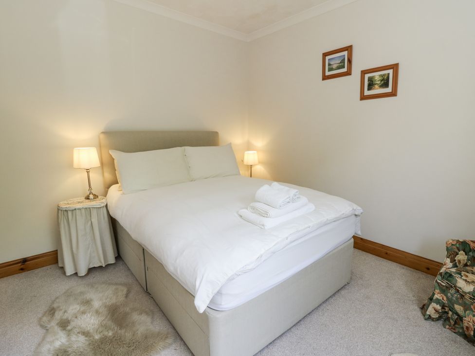 A bedroom with a bed and bedside lamps at Kala in Spittal near Haverfordwest