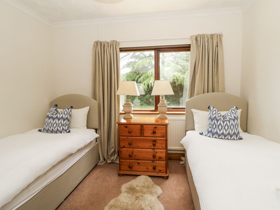 A bedroom with two single beds and a wooden dresser at Kala in Spittal near Haverfordwest