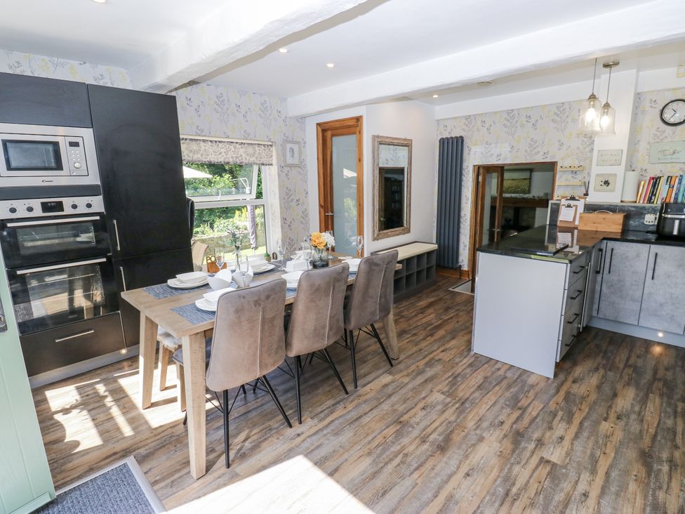 A kitchen with dining table and chairs at Springhead Cottage, Haworth