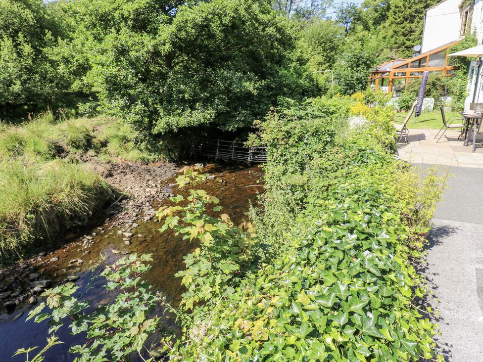 A view of a stream and greenery at Springhead Cottage in Haworth