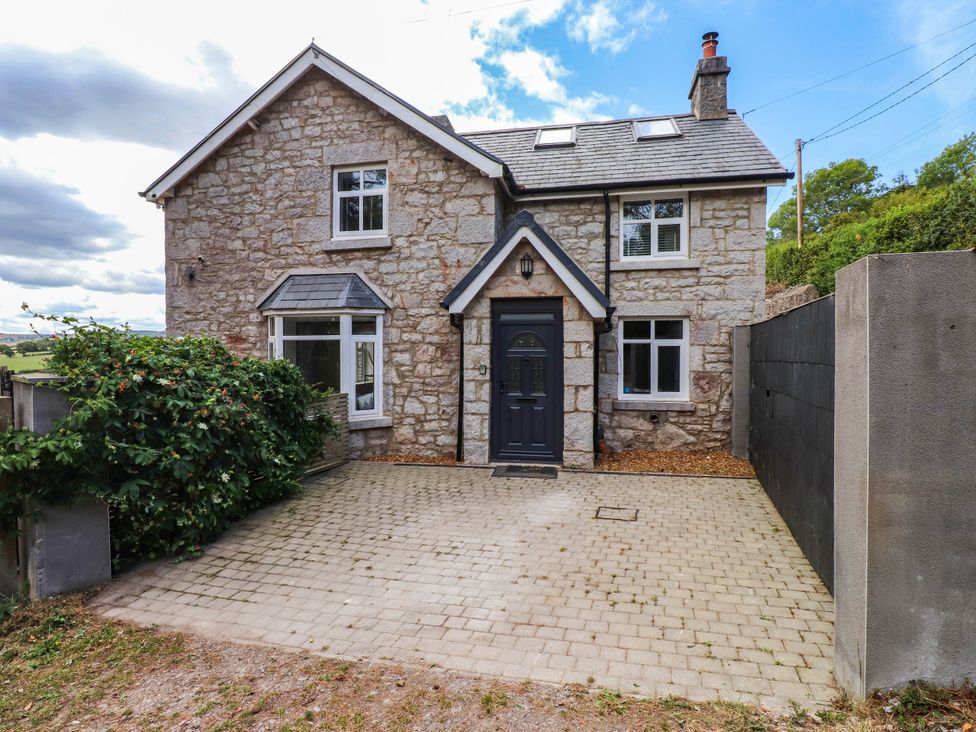 A house with a driveway and windows at Tyddyn Elidir near Old Colwyn