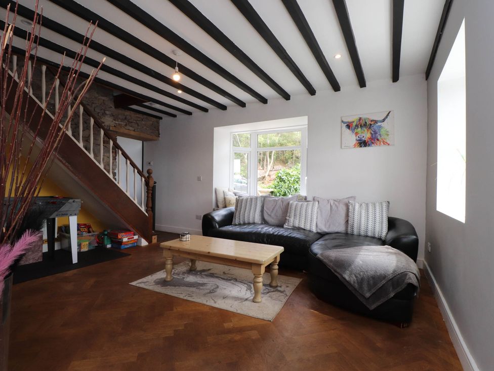 A living room with a sofa and coffee table at Tyddyn Elidir near Old Colwyn