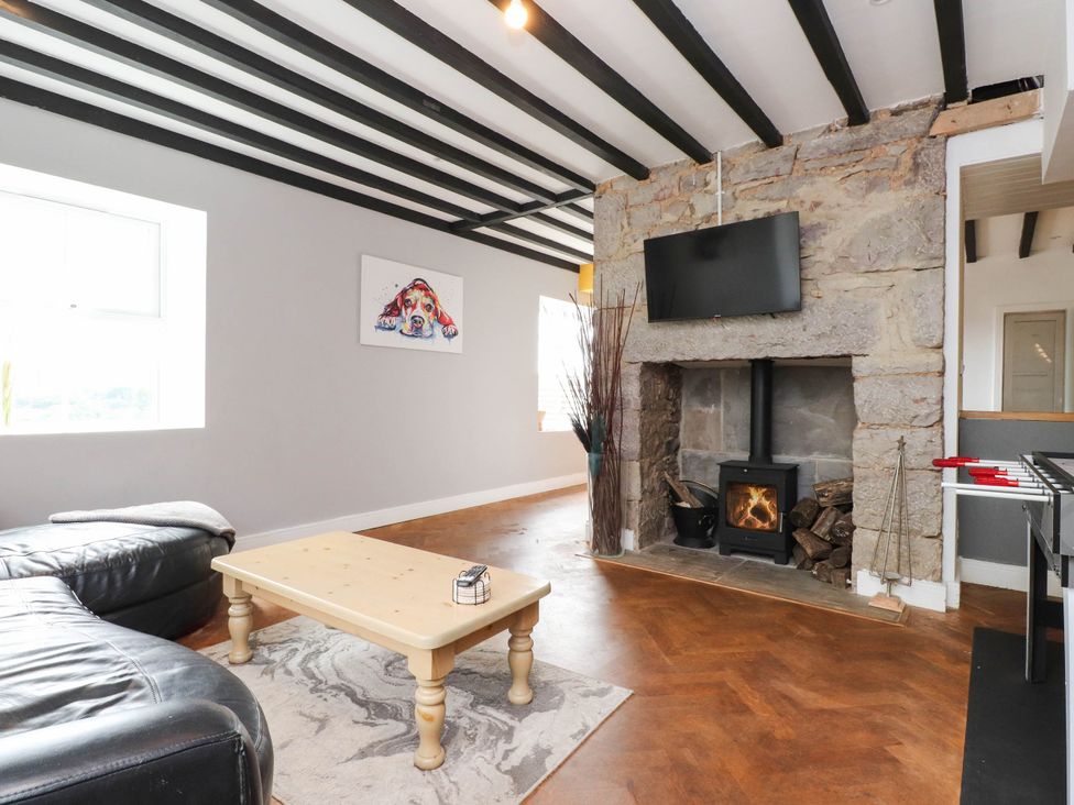 A living room with a sofa and a coffee table at Tyddyn Elidir near Old Colwyn