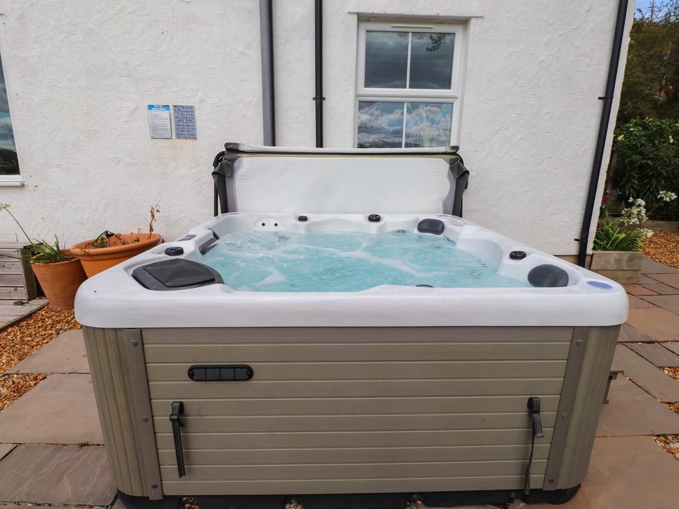A hot tub in an outdoor area at Tyddyn Elidir near Old Colwyn