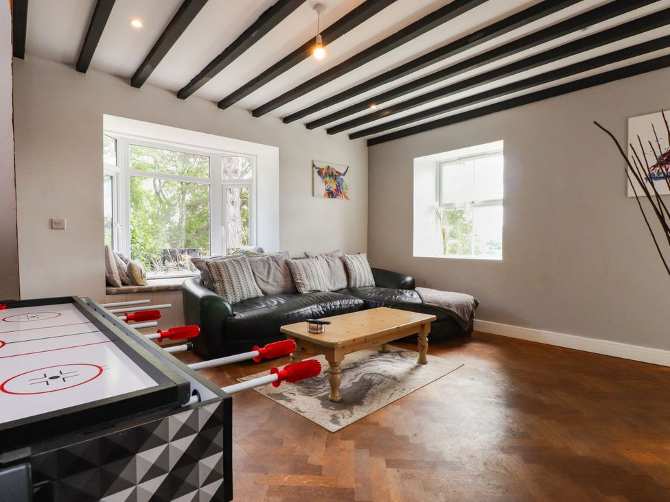 A living room with a sofa and coffee table at Tyddyn Elidir near Old Colwyn