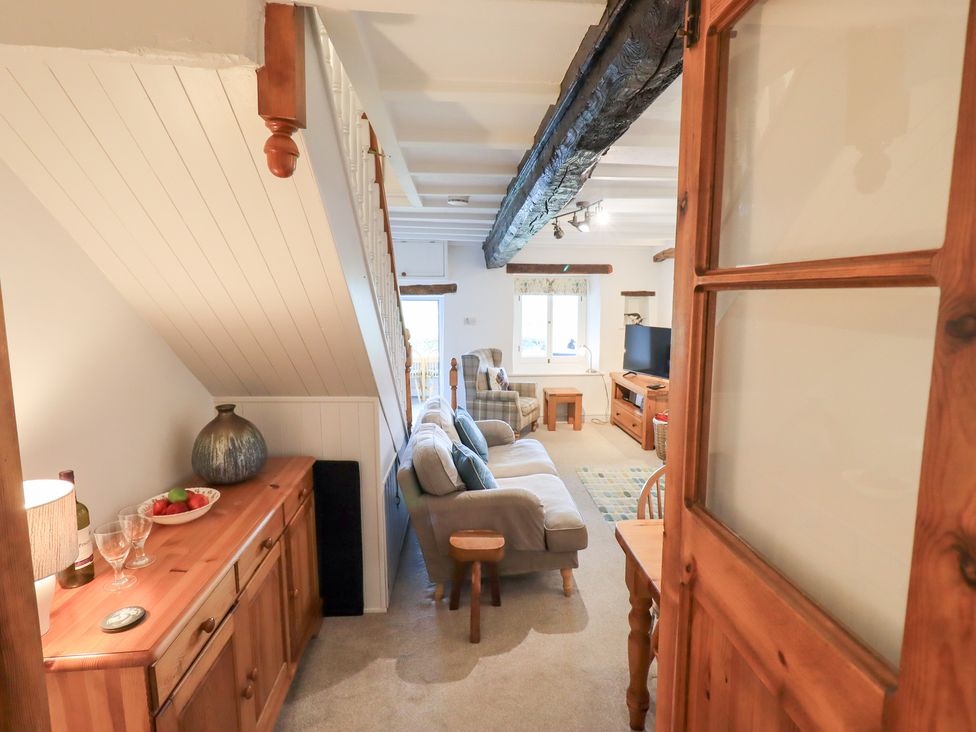 A living room with a couch and television at Squirrel Cottage in Bassenthwaite