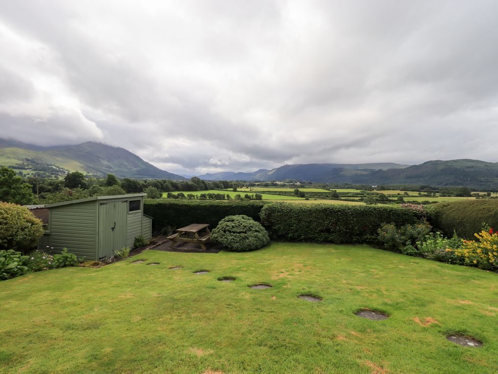 A garden with a shed and table at Squirrel Cottage in Bassenthwaite