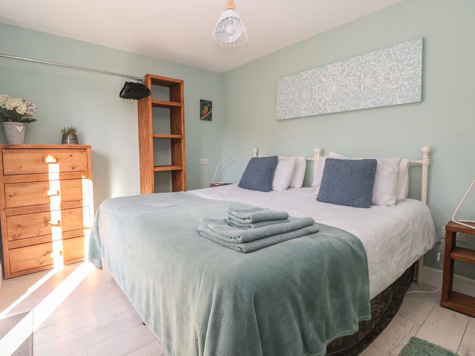 A bedroom with a bed and dresser at Meadowbank Lodge in Brandesburton