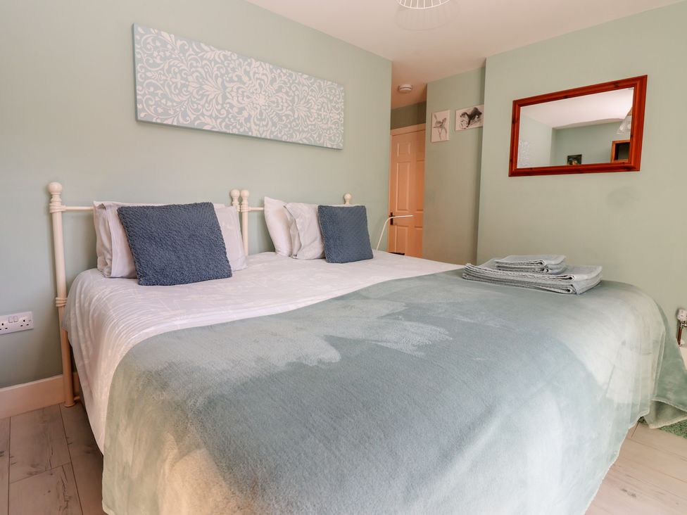 A bedroom with a bed and pillows at Meadowbank Lodge in Brandesburton
