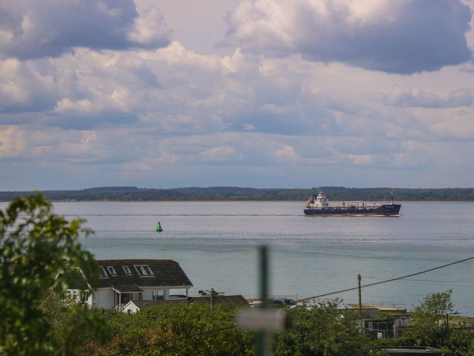 A ship sailing on water with a buoy near the shore at Aquanaut in Gurnard