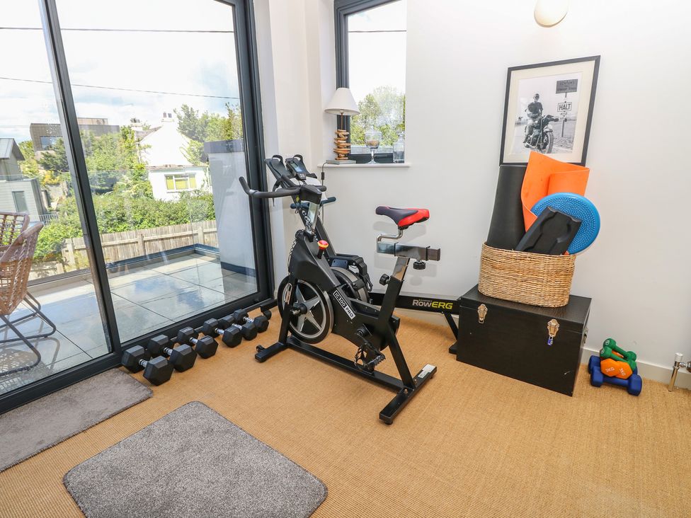 A home gym with an exercise bike and dumbbells at Aquanaut in Gurnard