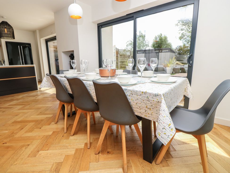 A dining room with a table set for meals at Aquanaut in Gurnard