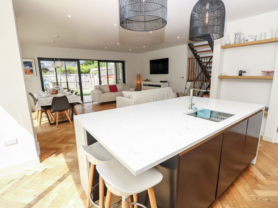 A kitchen with an island and dining area at Aquanaut in Gurnard