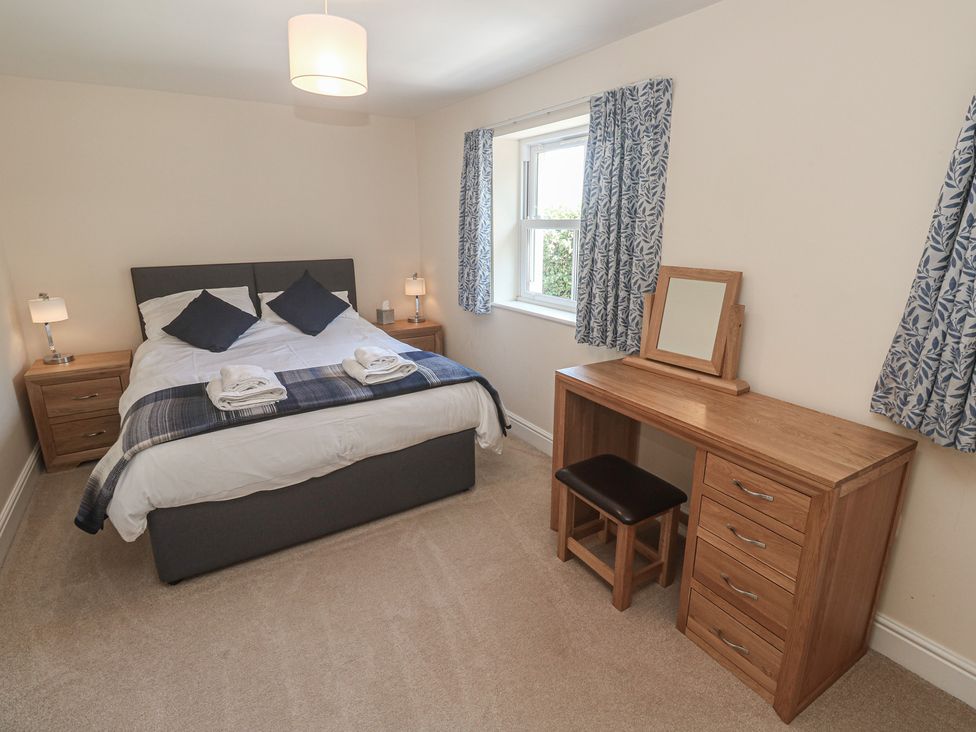A bedroom with a bed and desk at Ilgram in St Newlyn East