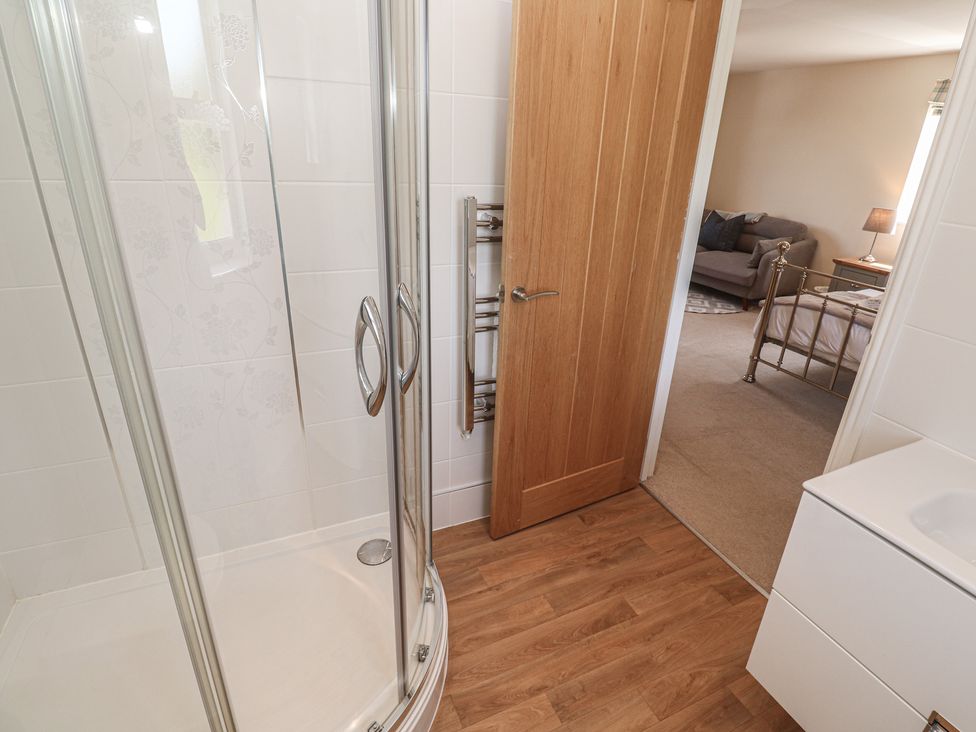 A bathroom with a shower and sink at Ilgram St Newlyn East