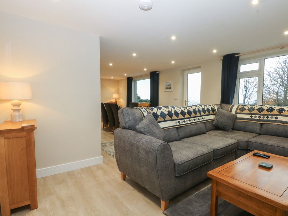 A living room with a sofa and coffee table at Caledfryn in Benllech