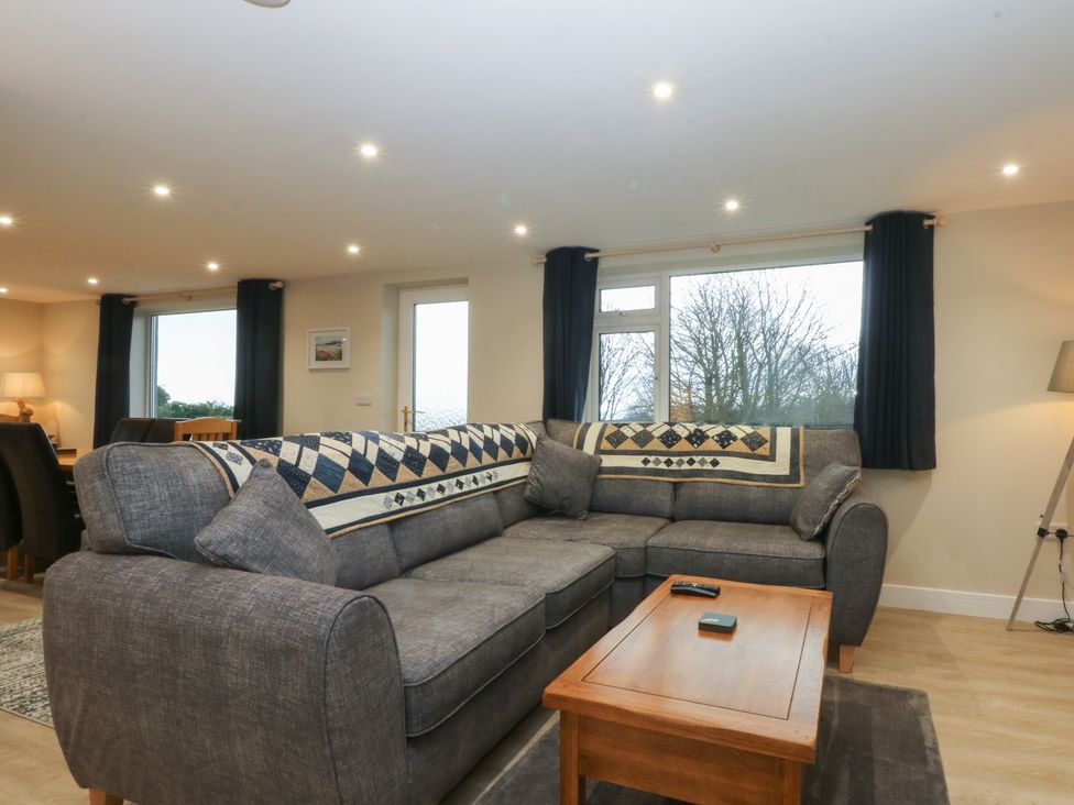 A living room with a sofa and coffee table at Caledfryn in Benllech