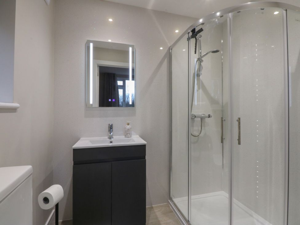 A bathroom with a shower and sink at Caledfryn Benllech