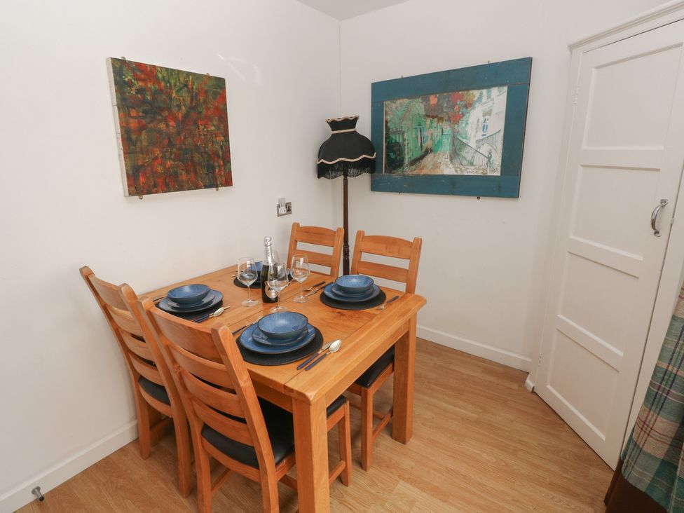 A dining room with a table set for dinner at Llys-Yr-Onnen in Carmarthen