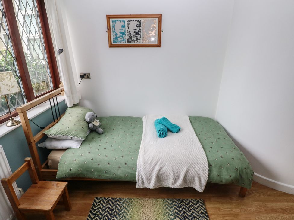 A bedroom with a bed and a toy at Llys-Yr-Onnen in Carmarthen
