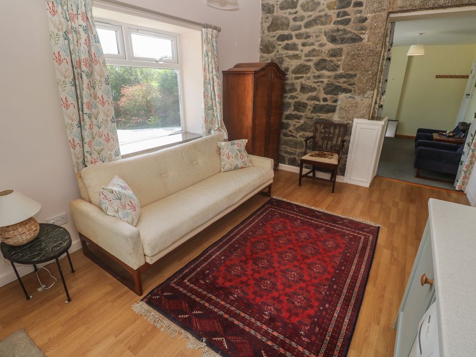 A living room with a sofa and rug at Penmarth House Coverack
