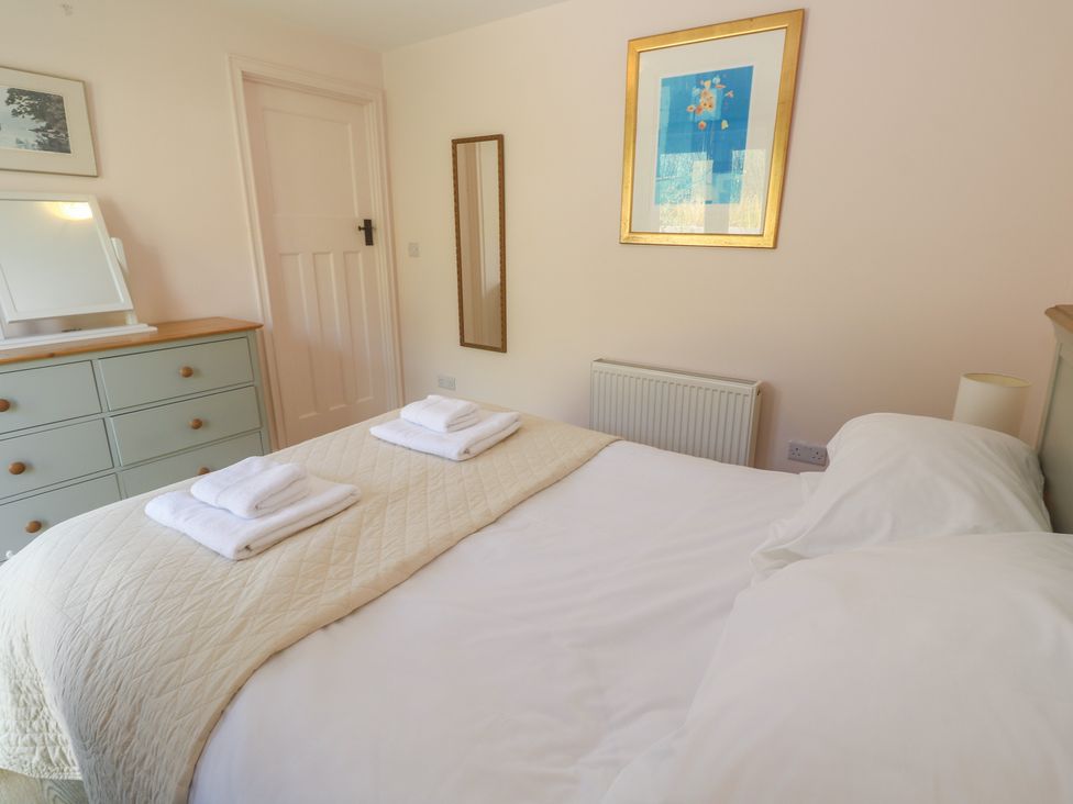 A bedroom with a bed and wardrobe at Penmarth House Coverack