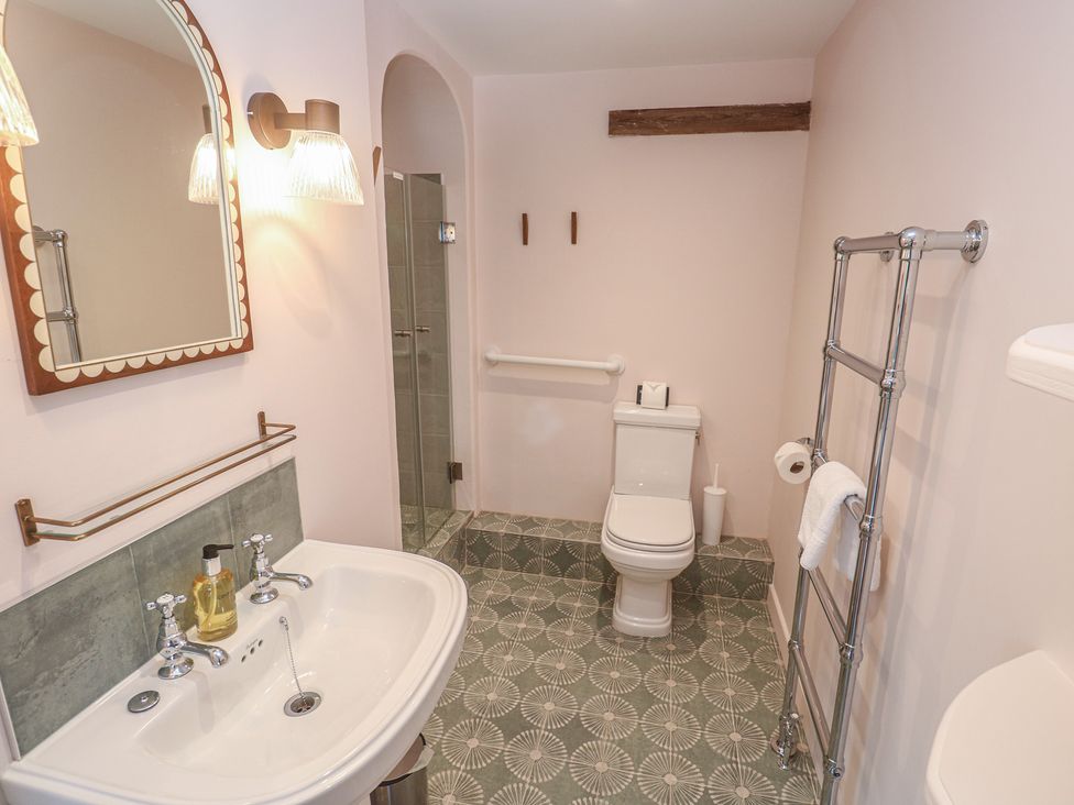 A bathroom with sink, toilet, and shower at Penmarth House Coverack