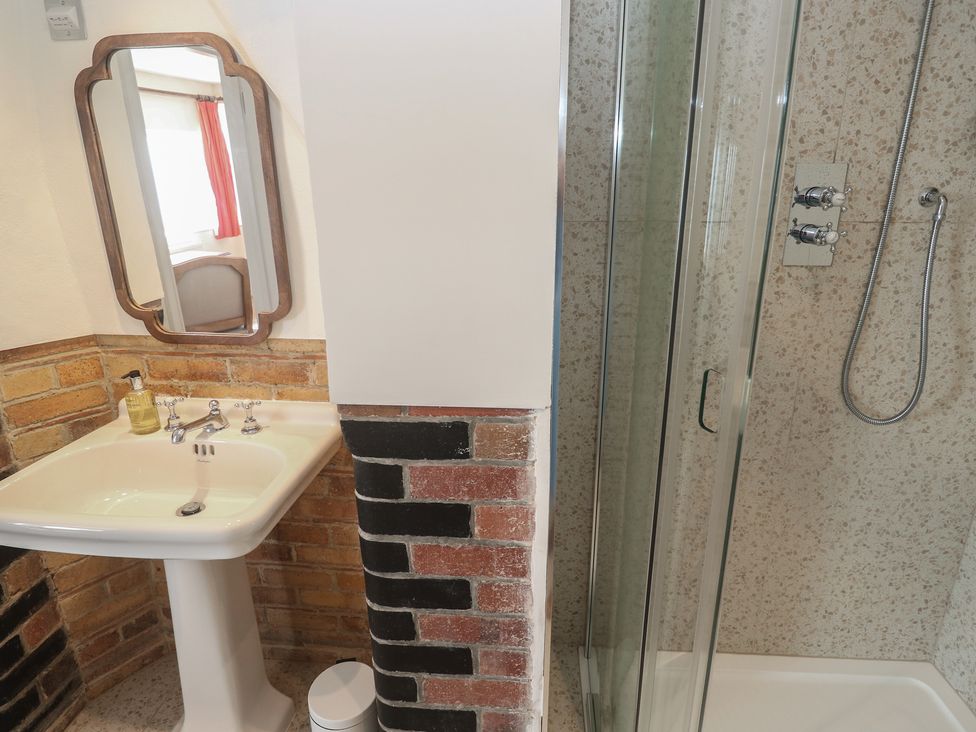 A bathroom with a washbasin and shower at Penmarth House Coverack