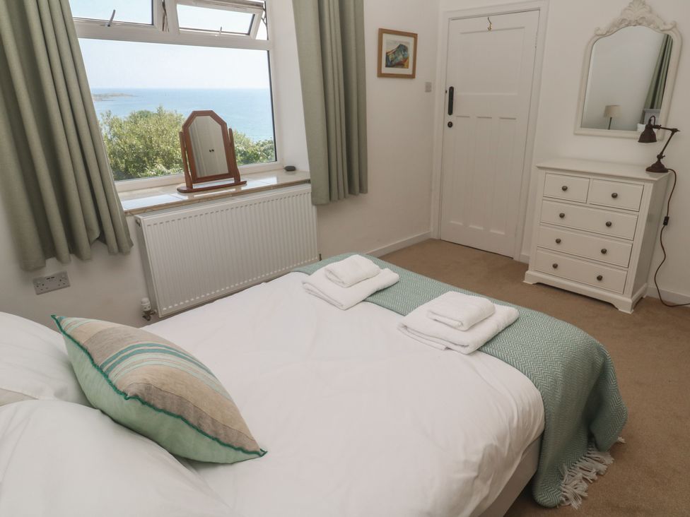 A bedroom with a bed and a view at Penmarth House in Coverack