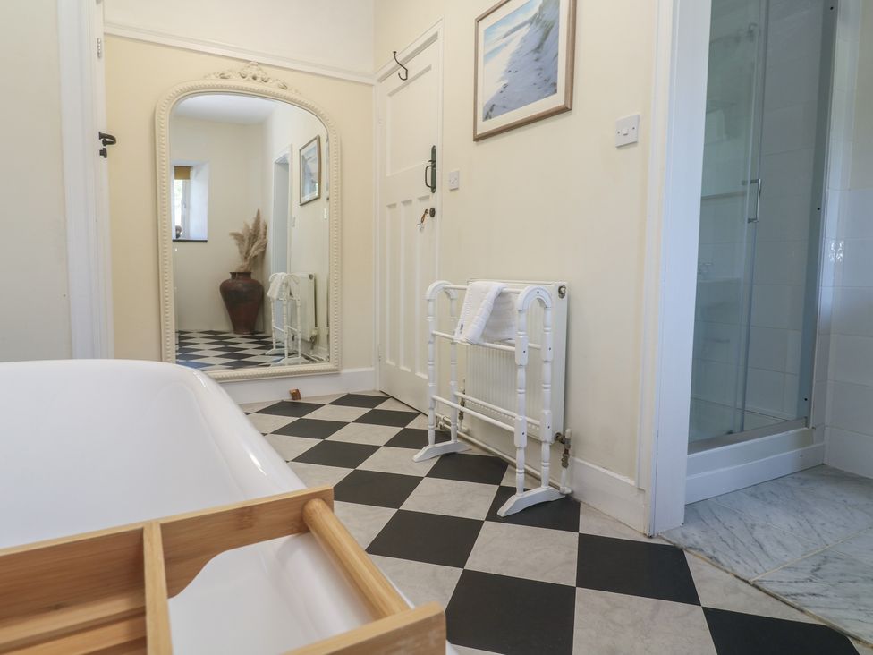 A bathroom with a bathtub and shower at Penmarth House Coverack
