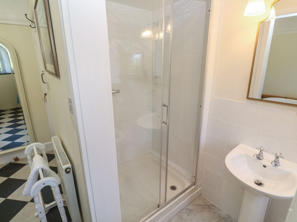 A bathroom with a shower and sink at Penmarth House Coverack