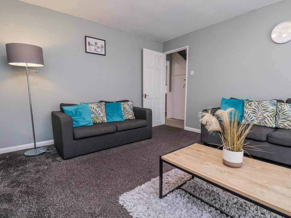 A living room with sofas and a coffee table at 34 Fountain Close in Whitby