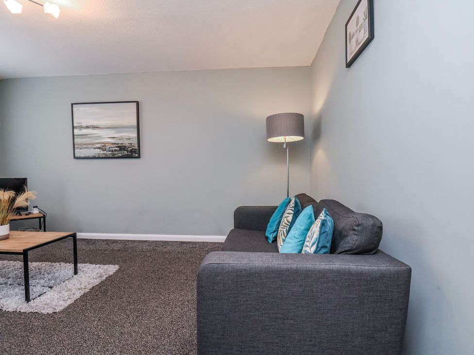 A living room with a sofa and coffee table at 34 Fountain Close in Whitby