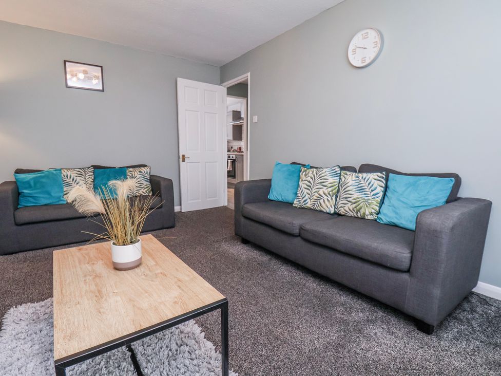 A living room with sofas and a coffee table at 34 Fountain Close in Whitby