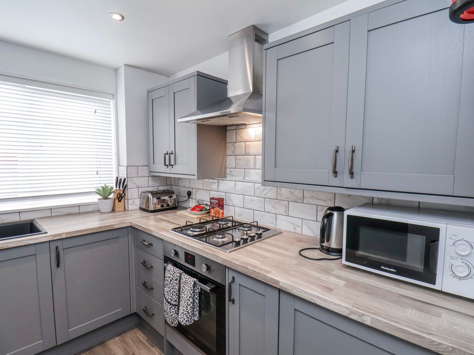 A kitchen with cabinets and appliances at 34 Fountain Close in Whitby