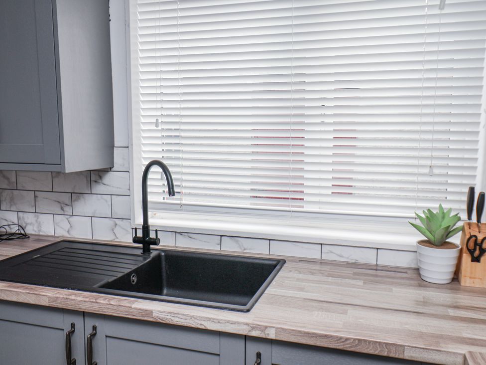 A kitchen with a sink and faucet at 34 Fountain Close in Whitby