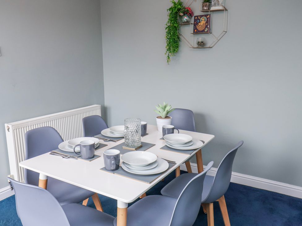 A dining room setup with a table and six chairs at 34 Fountain Close in Whitby