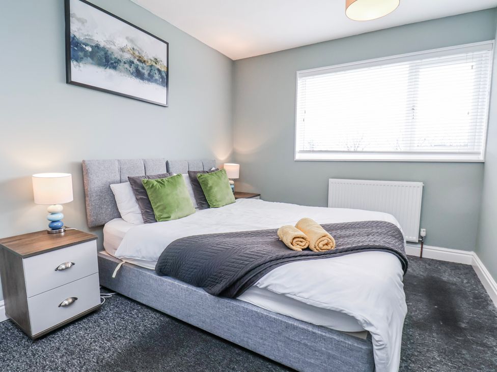 A bedroom with a bed and bedside lamps at 34 Fountain Close in Whitby