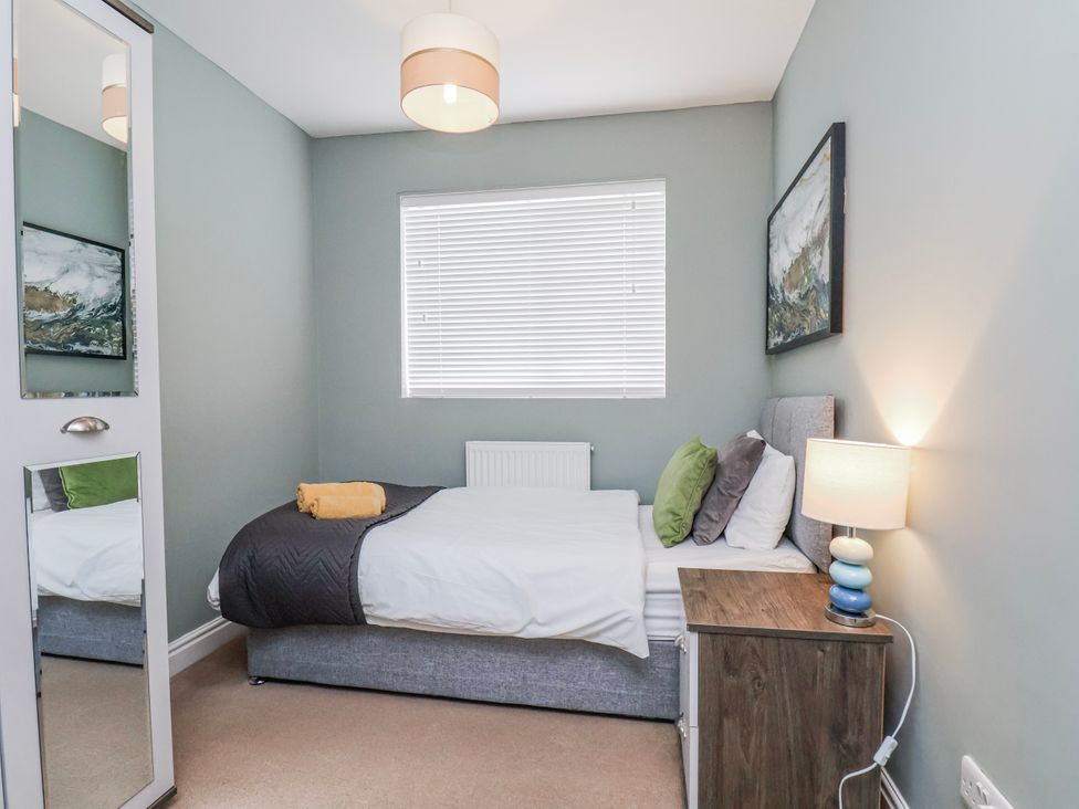 A bedroom with a bed and bedside table at 34 Fountain Close in Whitby