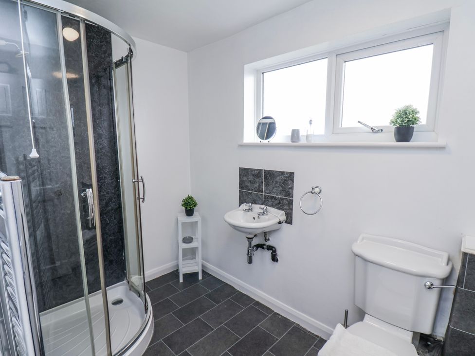A bathroom with shower, sink, and toilet at 34 Fountain Close Whitby